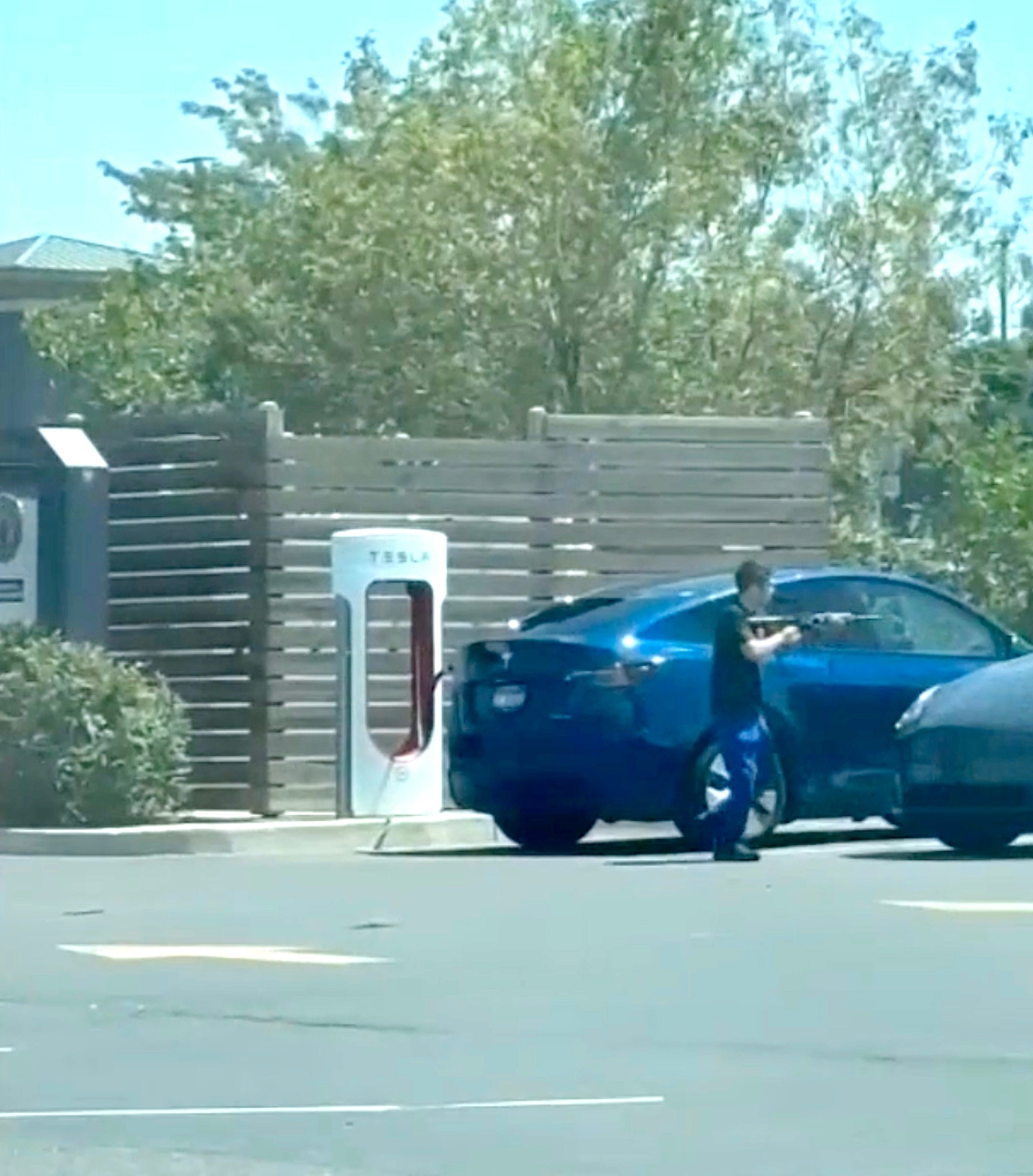 A bystander video verified by ABC News shows an alleged gunman preparing to open fire on a vehicle, Aug. 1, 2026, near an In-N-Out Burger restaurant in Twin Falls, Idaho.Obtained by ABC News