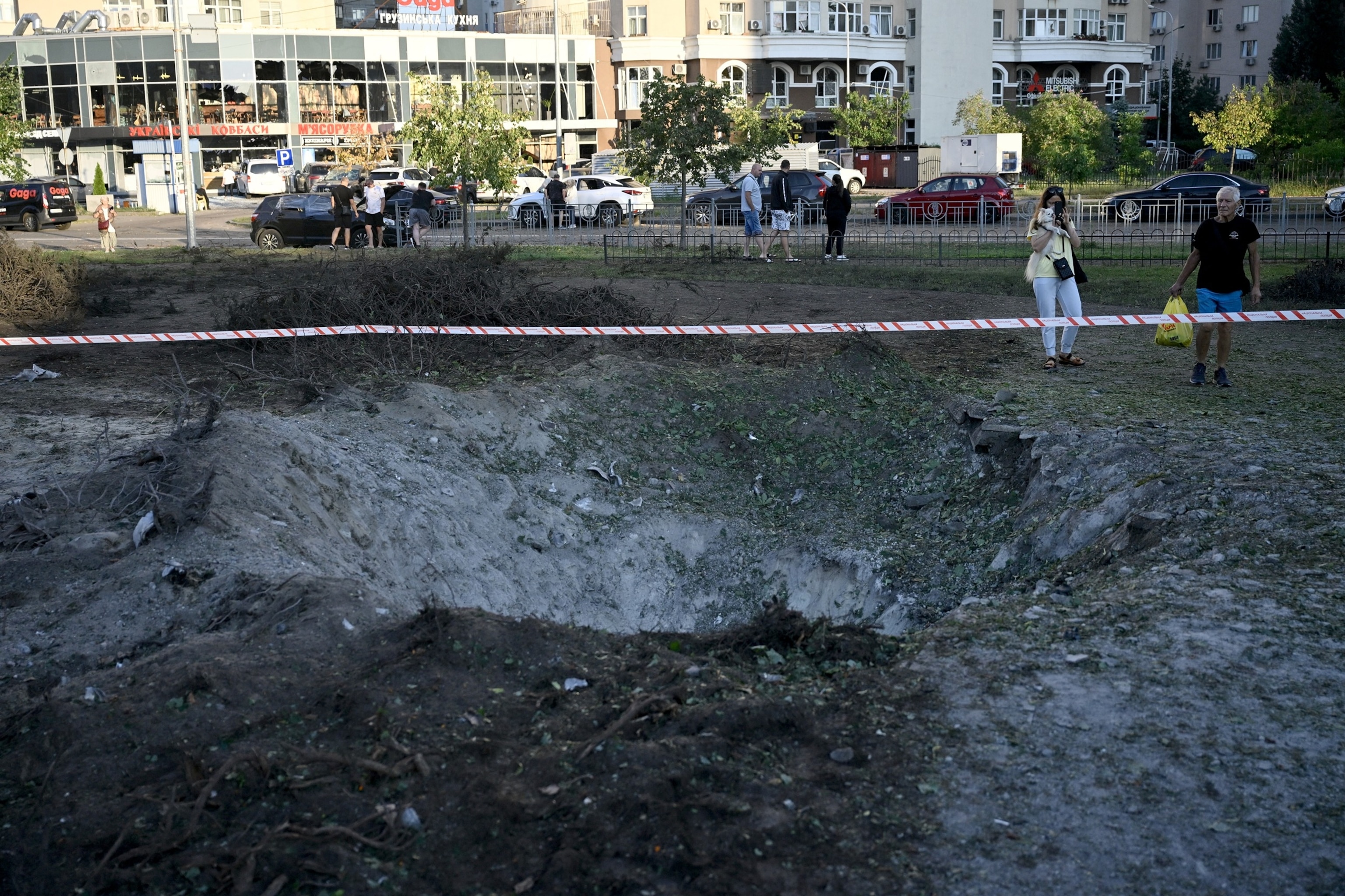 People examine a crater from Russian ballistic missile near children's clinic following strikes in the Ukrainian capital of Kyiv on August 1, 2026.Genya Savilov/AFP via Getty Images