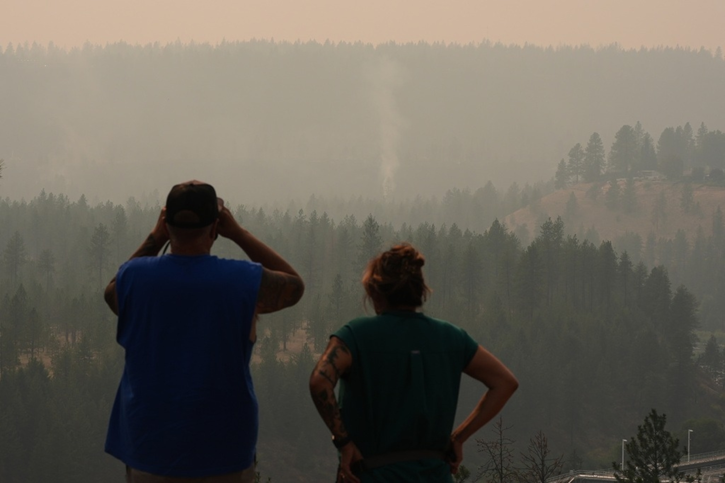 People view smoke rising from the Old Trails wildfire in the northwest part of Spokane, Wash., Monday, Aug. 3, 2026. (AP Photo/Lindsey Wasson)Lindsey Wasson/AP Photo