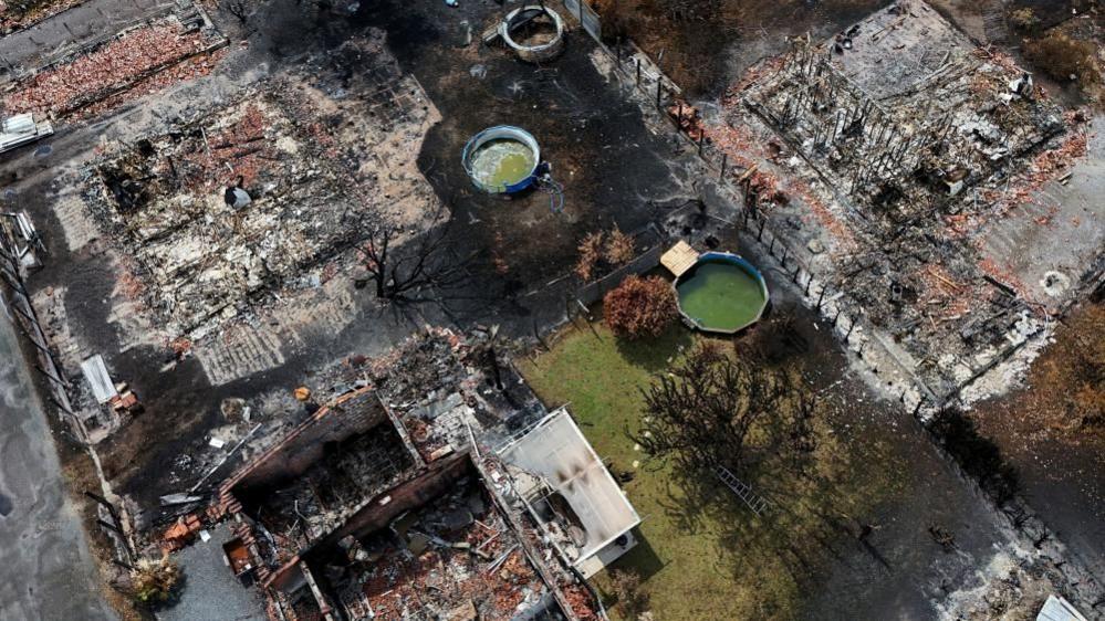 Image caption,A drone view of buildings destroyed by a wildfire in Le Porge