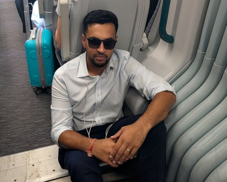 Akshay Vaghela often has no choice but to sit on the floor for long stretches of his journey.Photograph: Sammy Gecsoyler/The Guardian