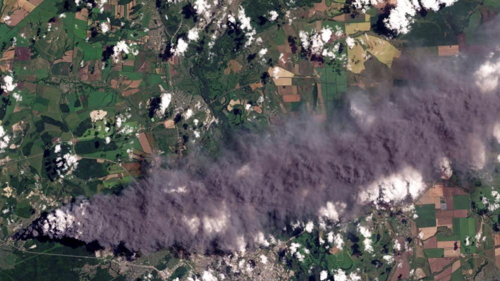 Image caption,A satellite image shows smoke rising out of a Wildberries facility hit on Sunday