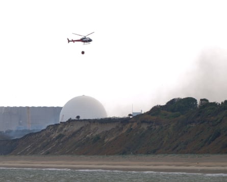 A helicopter carries water collected from the sea near Sizewell B nuclear power station to drop on a nearby wildfire last week.Photograph: Joe Giddens/PA