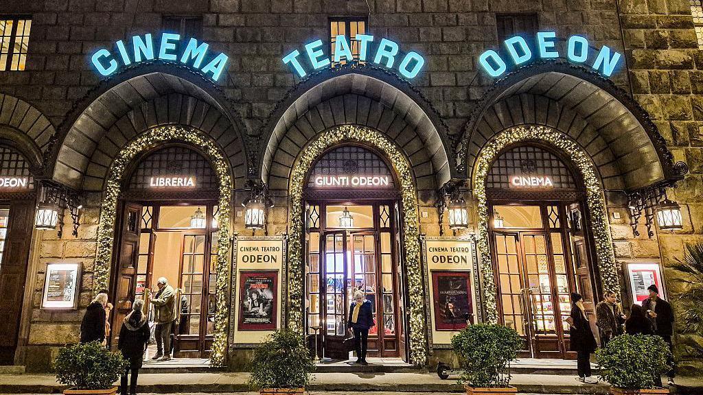 Image caption,One of Florence's tour guides suggests heading to the Odeon cafe and bookstore to cool down