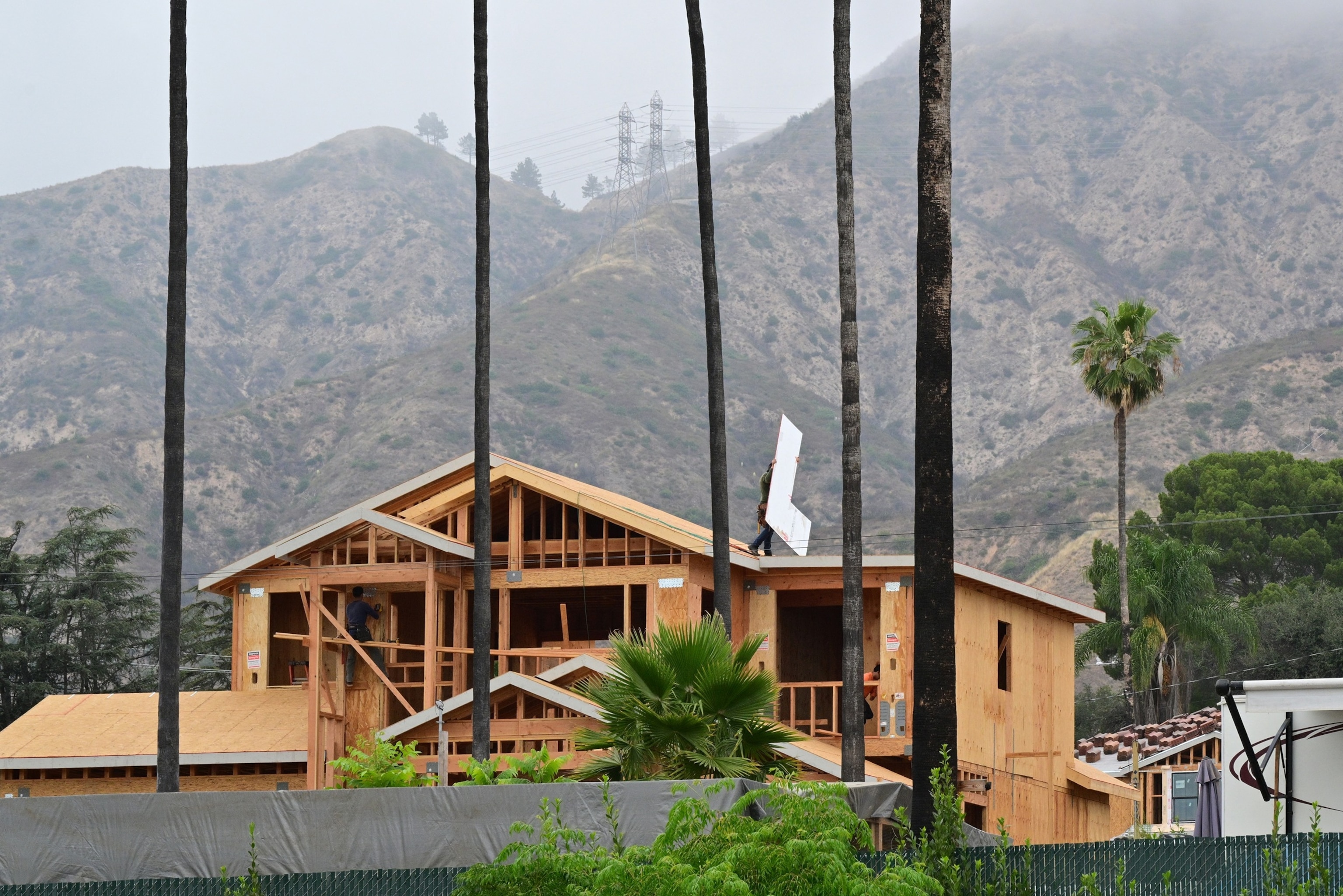 Contractors work on building a new house, June 29, 2026, on a property in Altadena, California, that was burned by the January 2025 Eaton Fire.Frederic J. Brown/AFP via Getty Images