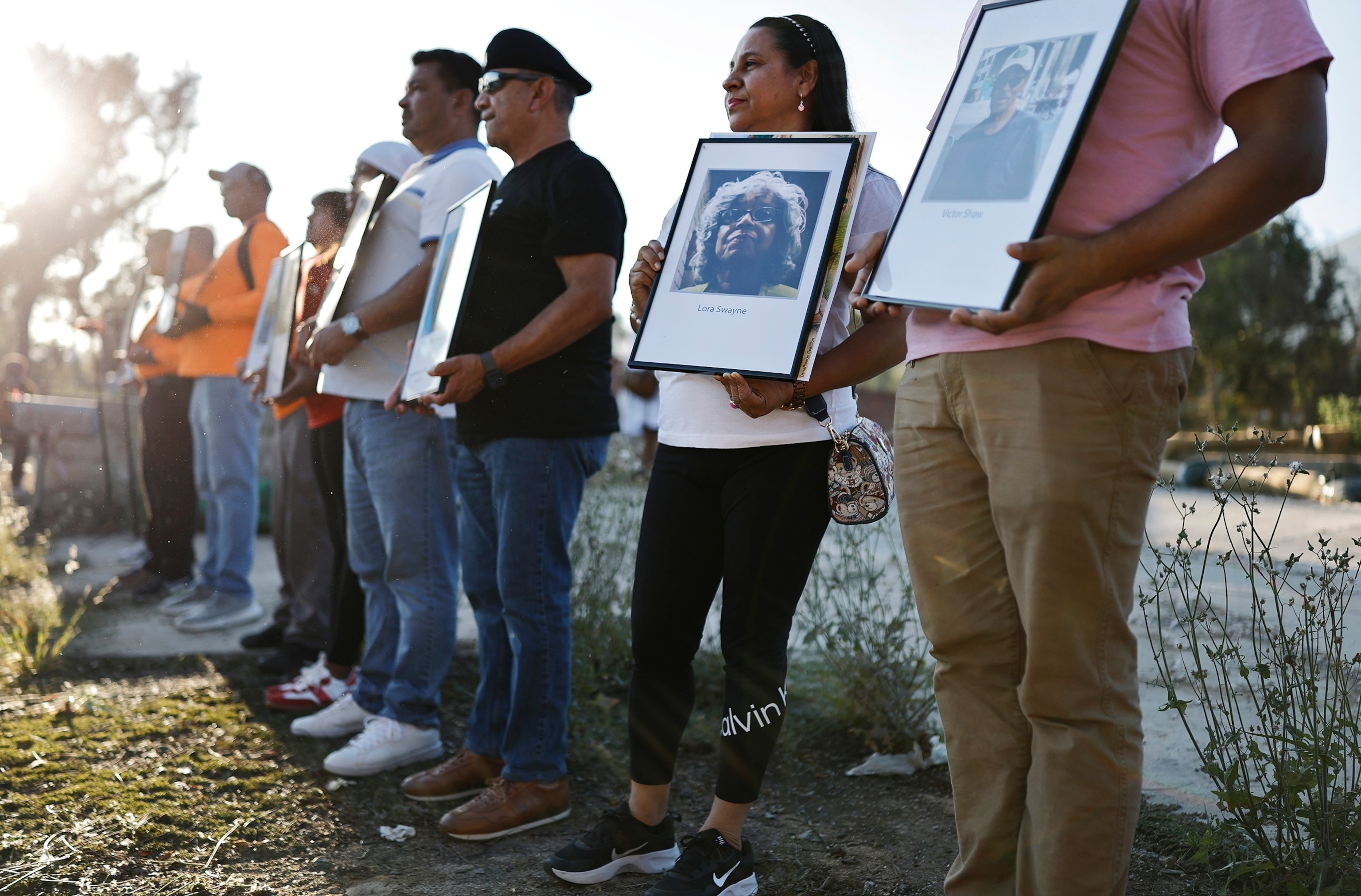 People hold photos of those who perished in the Eaton Fire during a memorial service, July 7, 2025, honoring the 19 lives lost in Altadena, California.Mario Tama/Getty Images