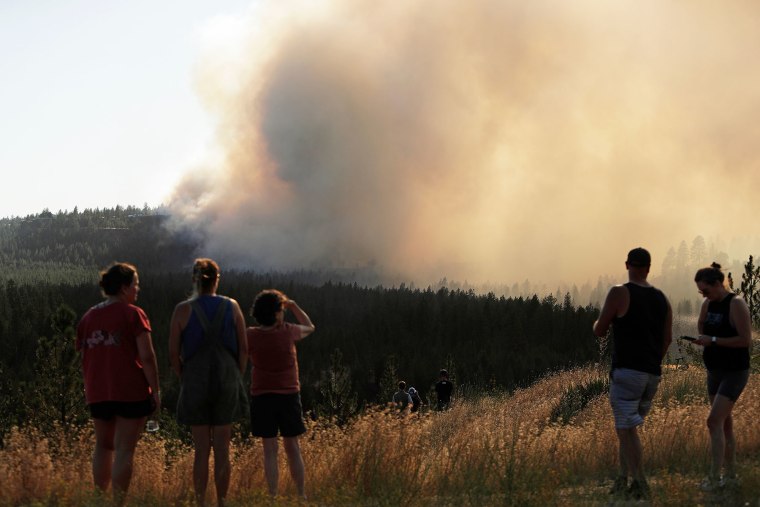 People watch the Old Trails Fire in Spokane, Wash., on Aug. 1.Young Kwak / AP