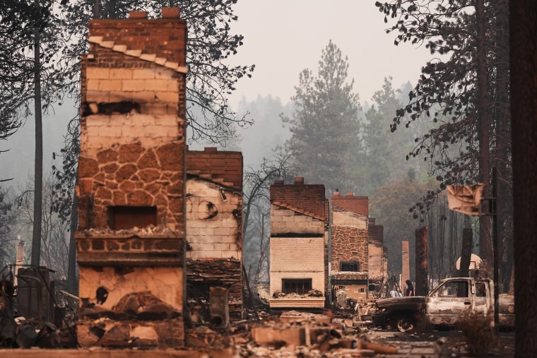 Chimneys are the only structures remaining in a residential neighborhood after a wildfire hit the northern part of Spokane, Wash., on Monday.Lindsey Wasson / AP
