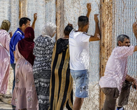 People in Fnideq wait at the Ceuta border hoping to see their missing friends or relatives.Photograph: Abdel Majid Bziouat/AFP/Getty Images