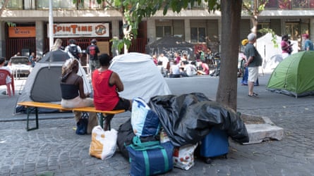 Young people with the belongings they managed to save before the eviction. Residents are now living on the street, carrying their possessions in suitcases and bags.Photograph: Claudia Deganutti