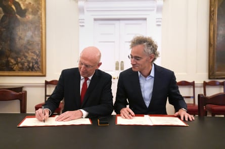 Alex Karp, the CEO of Palantir, right, signs a deal with the UK’s then defence secretary, John Healey, in September last year. Palantir was awarded a three-year, £240m contract with the MoD last December.Photograph: Lucy North/PA