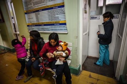 Mothers wait with their children for a medical examination at La Oroya’s health clinic, 2013.Photograph: Bloomberg/Getty Images