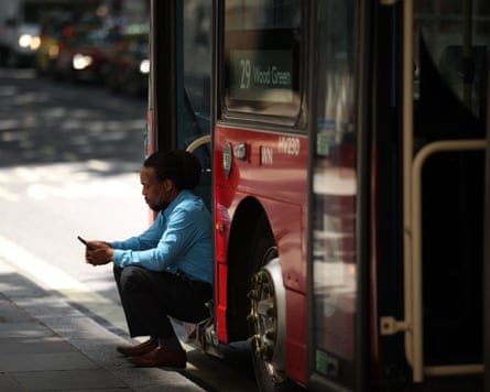 A London bus driver takes a break in the shade on a day the weather exceeded 30C.Photograph: Dan Kitwood/Getty Images