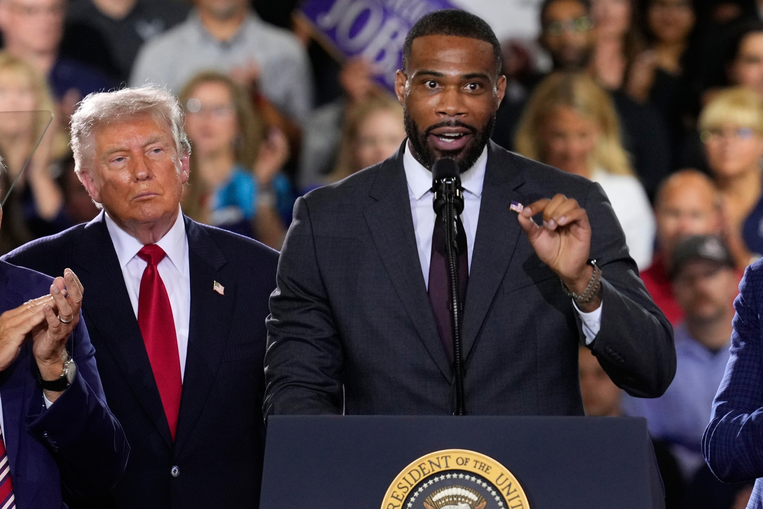 President Donald Trump listens as Republican congressional candidate Amir Hassan speaks at an event at the General Motors Proving Ground on July 27, 2026, in Milford, Mich.Paul Sancya/AP Photo