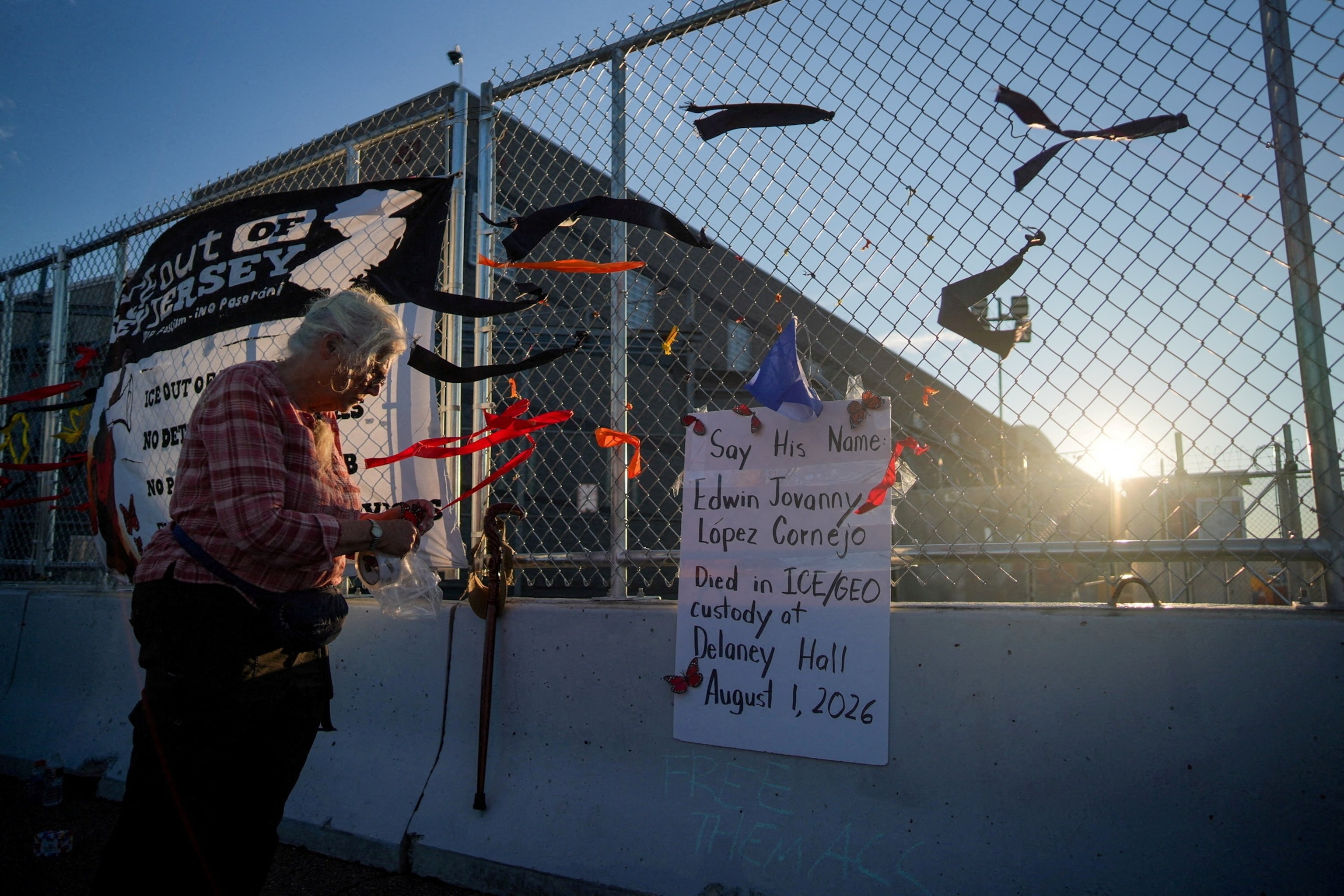 A protester ties a ribbon with the name of detainees on a fence outside of Delaney Hall detention center, after a Salvadoran immigrant, Edwin Lopez-Cornejo, who was being held inside died on Saturday, in Newark, New Jersey, August 3, 2026.Ryan Murphy/Reuters