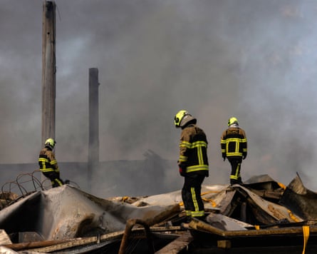 Ukrainian firefighters work to put out a fire following a massive Russian ballistic missile and drone strike on Kyiv.Photograph: Tetiana Dzhafarova/AFP/Getty Images