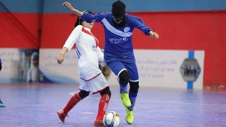 Image caption,Noori (in blue) used to wear a face mask to hide her identity when playing in Afghanistan