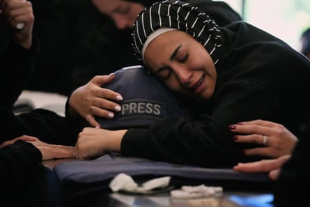 Zainab, the sister of Amal Khalil, mourns over her coffin in Baysariyeh, southern Lebanon.Photograph: Mohammed Zaatari/AP