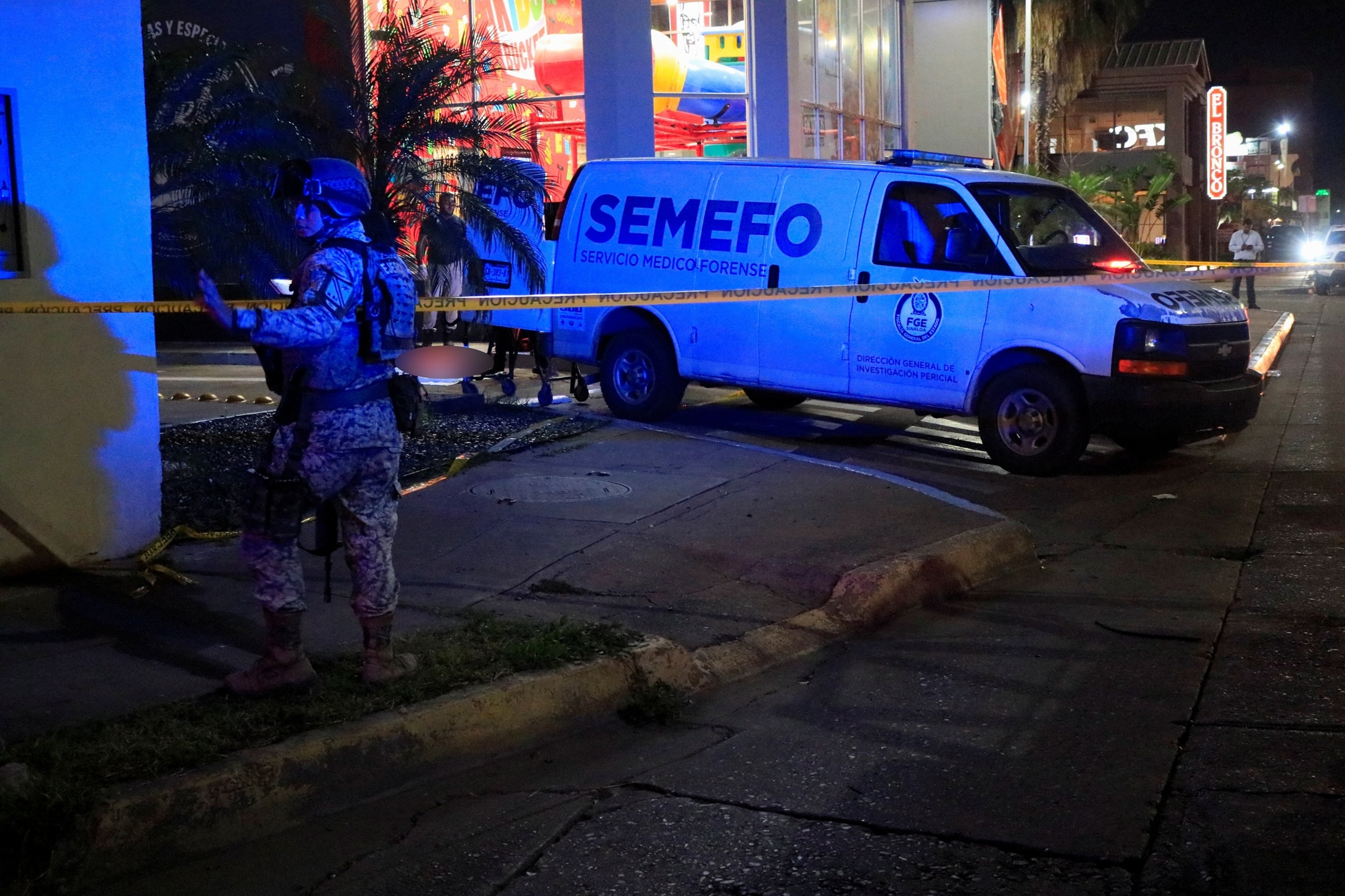 A soldier stands guard as forensic technicians and police officers work at the crime scene where Mexican social media influencer Cesar Gastelum, known for his comedy videos and followed by nearly 600,000 people on TikTok, was shot and killed while livestreaming with friends outside a fast-food restaurant in Culiacan, Sinaloa state, Mexico, Aug. 4, 2026.Jesus Bustamante/Reuters