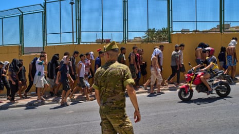 A young person is escorted by Spanish security forces after attempting to cross into Ceuta on Saturday.Photograph: Violeta Santos Moura/Reuters