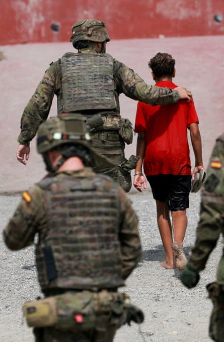 Red Cross personnel distributing food at  Trampolín beach in Ceuta this week.Photograph: REDUAN/EPA