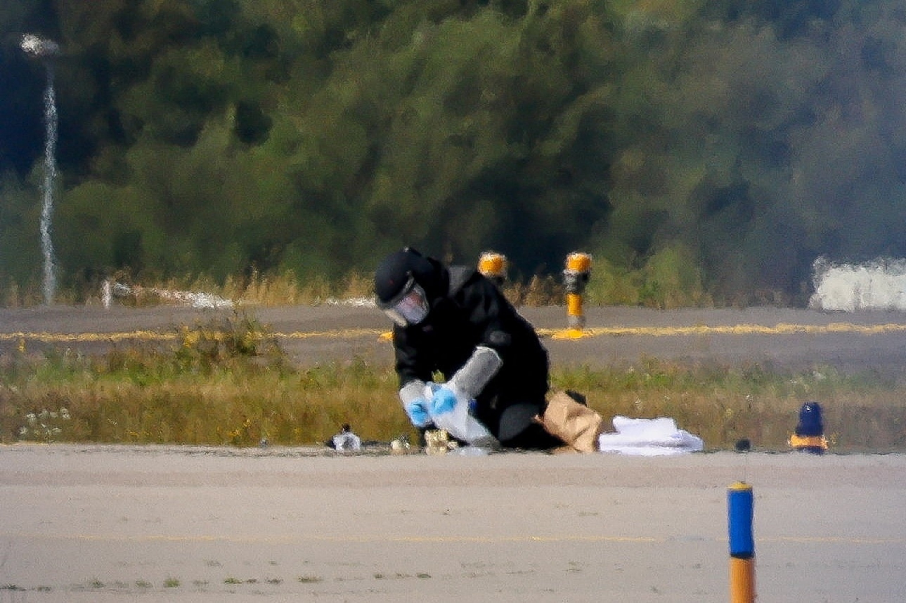 A police officer in protective clothing works at Leipzig/Halle Airport in Schkeuditz, Germany, August 5, 2026, after the police said explosives experts examined a drone near a runway, and after another cargo aircraft hit an unknown object as it was climbing away from the airport overnight, prompting an unscheduled landing in Hanover, according to a source familiar with the incident.Axel Schmidt/Reuters