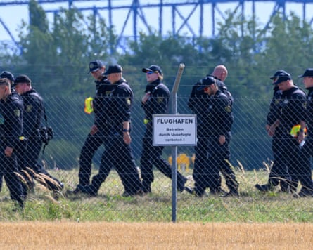 Police officers search an area at Leipzig airport after the discovery of the drone.Photograph: Hendrik Schmidt/DPA/AP
