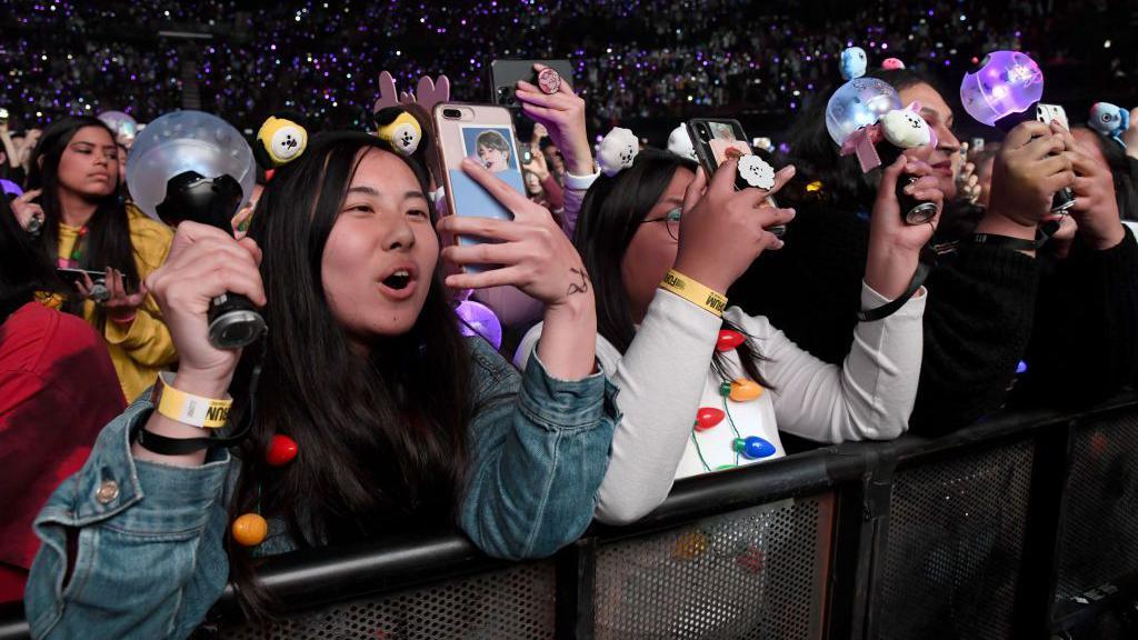 Image caption,Fans of BTS are no strangers to the band's sporadic calls to put down their phones at concerts