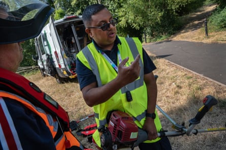 Mo Ghafoor helps out a first-time member.Photograph: Tom Pilston/The Guardian
