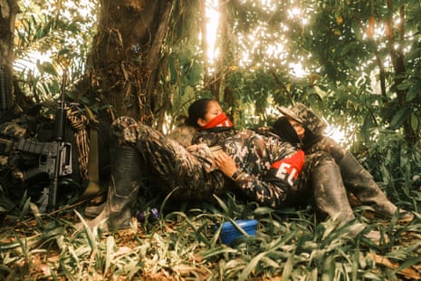 A female ELN member combs her hair at a camp in southern Chocó.Photograph: Santiago Mesa/The Guardian