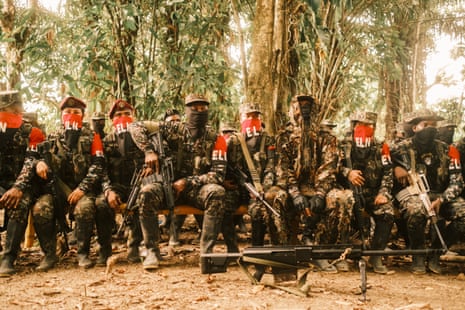 ELN members listen as Commander Yerson reads the group’s regulations at a camp in southern Chocó.Photograph: Santiago Mesa/The Guardian