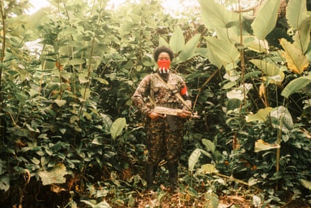 An ELN member poses for a photograph at a camp in southern Chocó.Photograph: Santiago Mesa/The Guardian