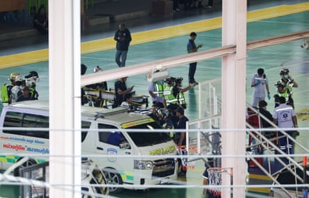 Thai police gather at the scene after a school shooting in Bang Kruai district, north of Bangkok.Photograph: Lillian Suwanrumpha/AFP/Getty Images