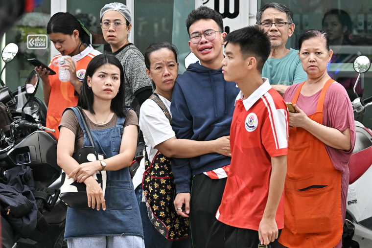 Students and parents gathered outside a school in Thailand’s Bang Kruai district, north of Bangkok after a school shooting on Friday.Lilian Suwanrumpha / AFP via Getty Images