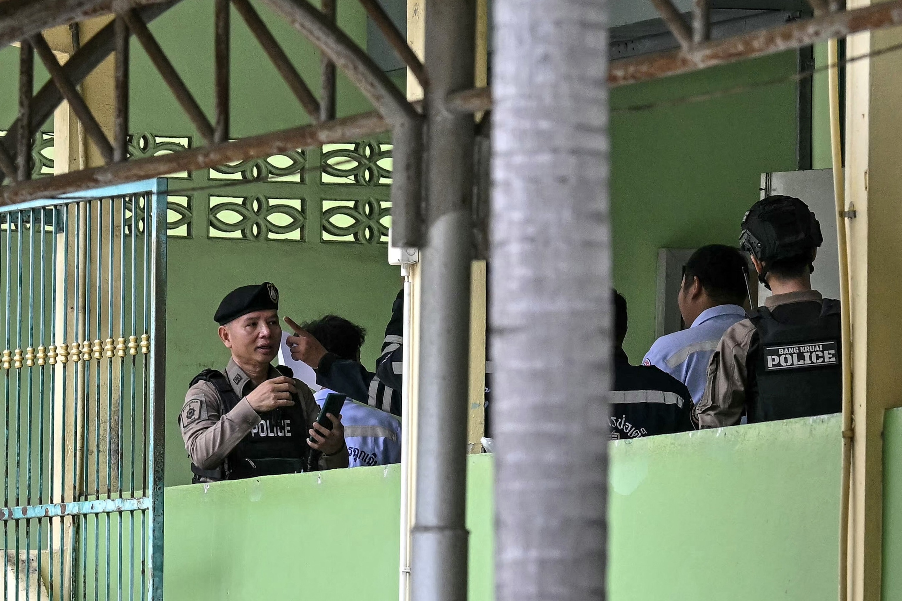 Police and emergency responders are pictured on the school premises following a shooting in Bang Kruai district, Bangkok, on August 7, 2026.Lillian Suwanrumpha/AFP via Getty Images