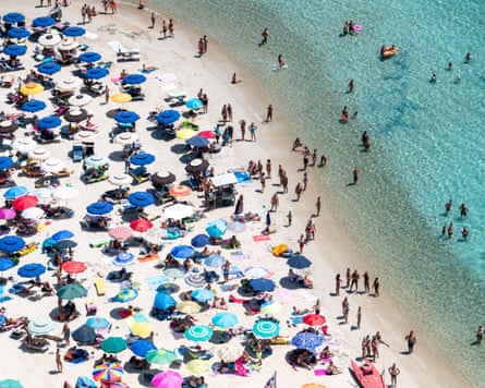 Umbrellas on a beach in Villasimius, Italy.Photograph: Fabrizio Villa/Getty Images