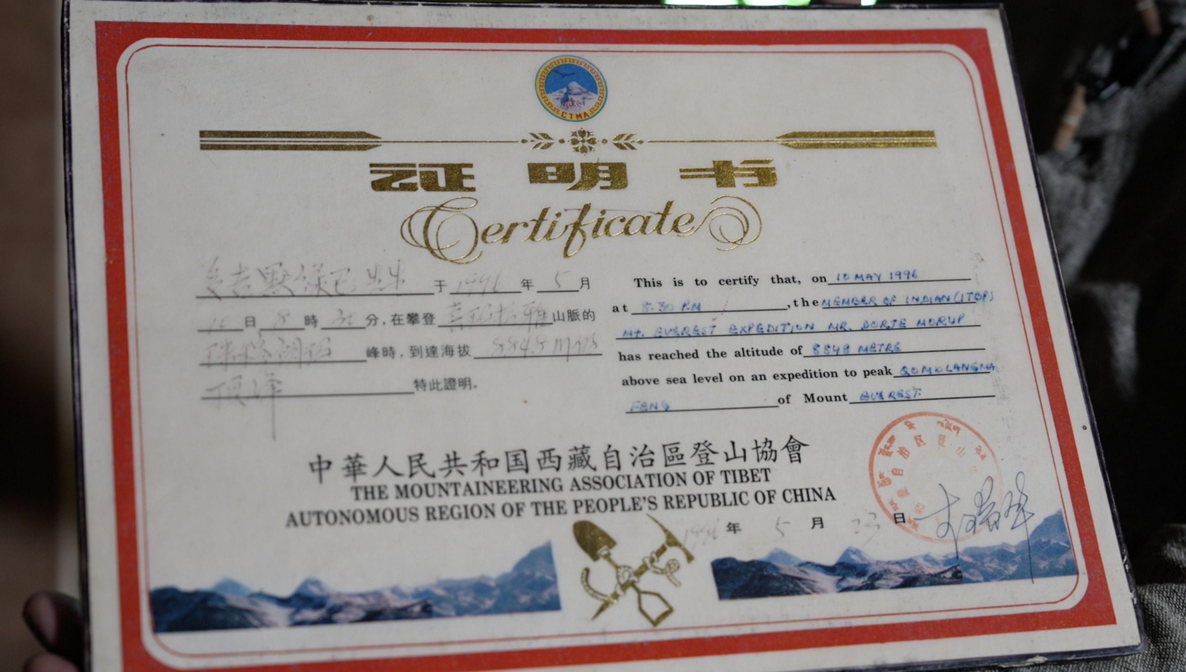 Image caption,Morup's family is proud to show the certificate issued by the Chinese government confirming he had successfully reached the top of Everest