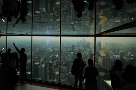 People look out at the smog caused by wildfire smoke from the CN Tower in Ontario last month. yellowish-grey in Canada’s largest city.Photograph: Cole Burston/AFP/Getty Images