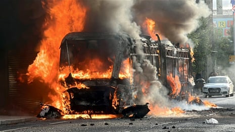 Bus set on fire as disorder flares up in Belfast – video