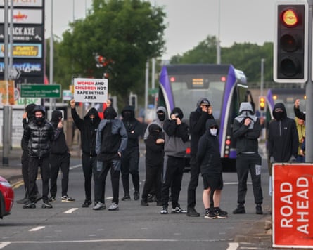 Protesters wore masks and hoods to obscure their identities.Photograph: Peter Morrison/AP