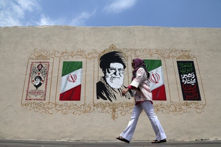 A woman walks by a mural in Tehran on Thursday. The Iranian regime has shown resilience since the death of its supreme leader on the war’s first day.Photograph: Anadolu/Getty Images
