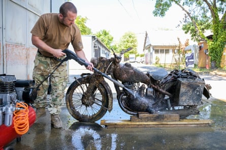 The head of mechanised military equipment at the defence ministry museum, József Bakondi, attends to the German motorcycle.Photograph: Tamas Purger/EPA