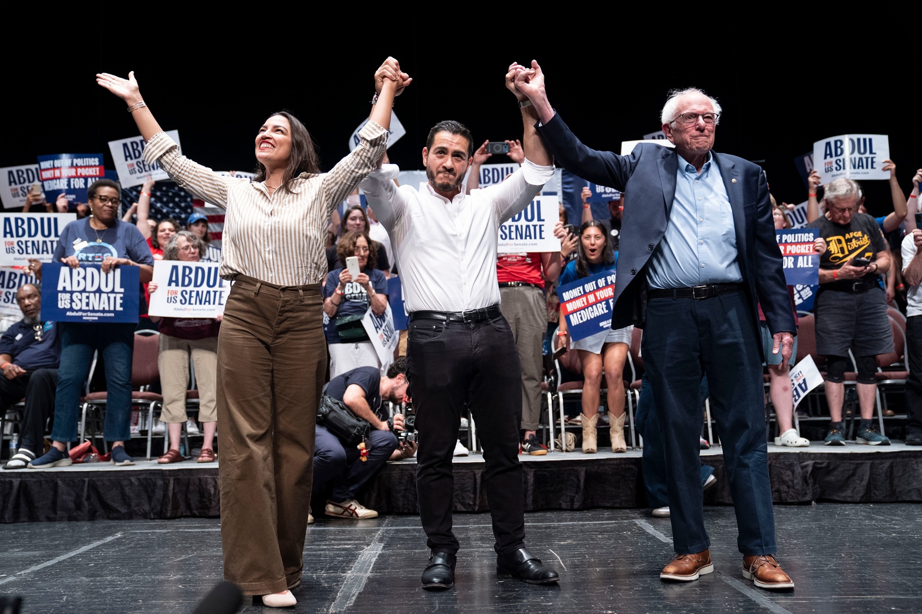 From left, Rep. Alexandria Ocasio-Cortez, D-N.Y., Michigan Democratic candidate for Senate Abdul El-Sayed and Sen. Bernie Sanders, I- Vt., greet the crowd after El-Sayed spoke at The People V. The Powerful rally at the Detroit Opera House on July 18, 2026 in Detroit, Michigan.Sarah Rice/Getty Images
