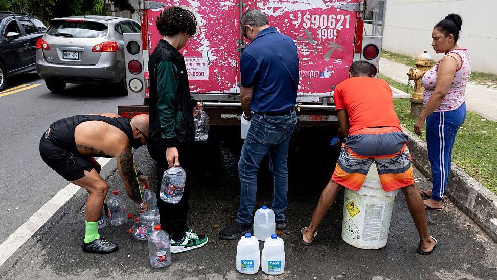 Image caption,Residents in capital San Juan filled up from water distribution trucks as the measure took effect