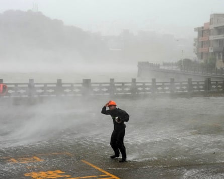 A struggles against high winds and driving rain in Dongsha, Zhejiang province, as Typhoon Dolphin makes landfall.Photograph: Huang Zongzhi/Xinhua/AP