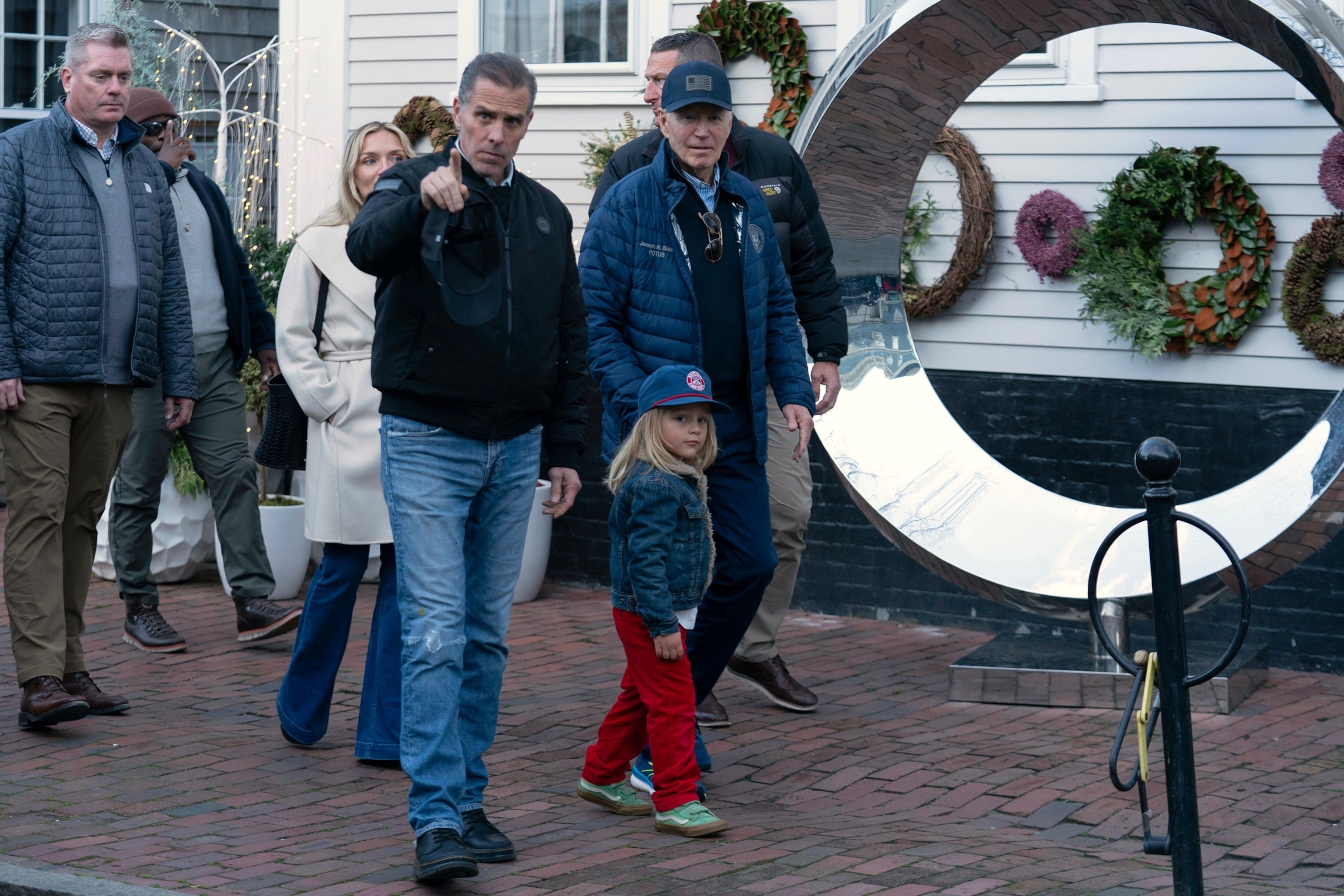 President Joe Biden, right, accompanied by his grandson Beau Biden and son Hunter Biden walk in downtown Nantucket, Massachusetts, on Nov. 29, 2024.Jose Luis Magana/AP