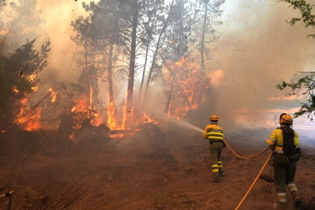 Firefighters battle a blaze in a forest in El Tiemblo, Castilla y León, on 25 July. The region is said to be one of the best to view the eclipse.Photograph: César Manso/AFP/Getty Images