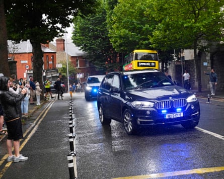 Onlookers take photos as the car carrying Daniel Kinahan passes on route to court.Photograph: Mark Marlow/PA
