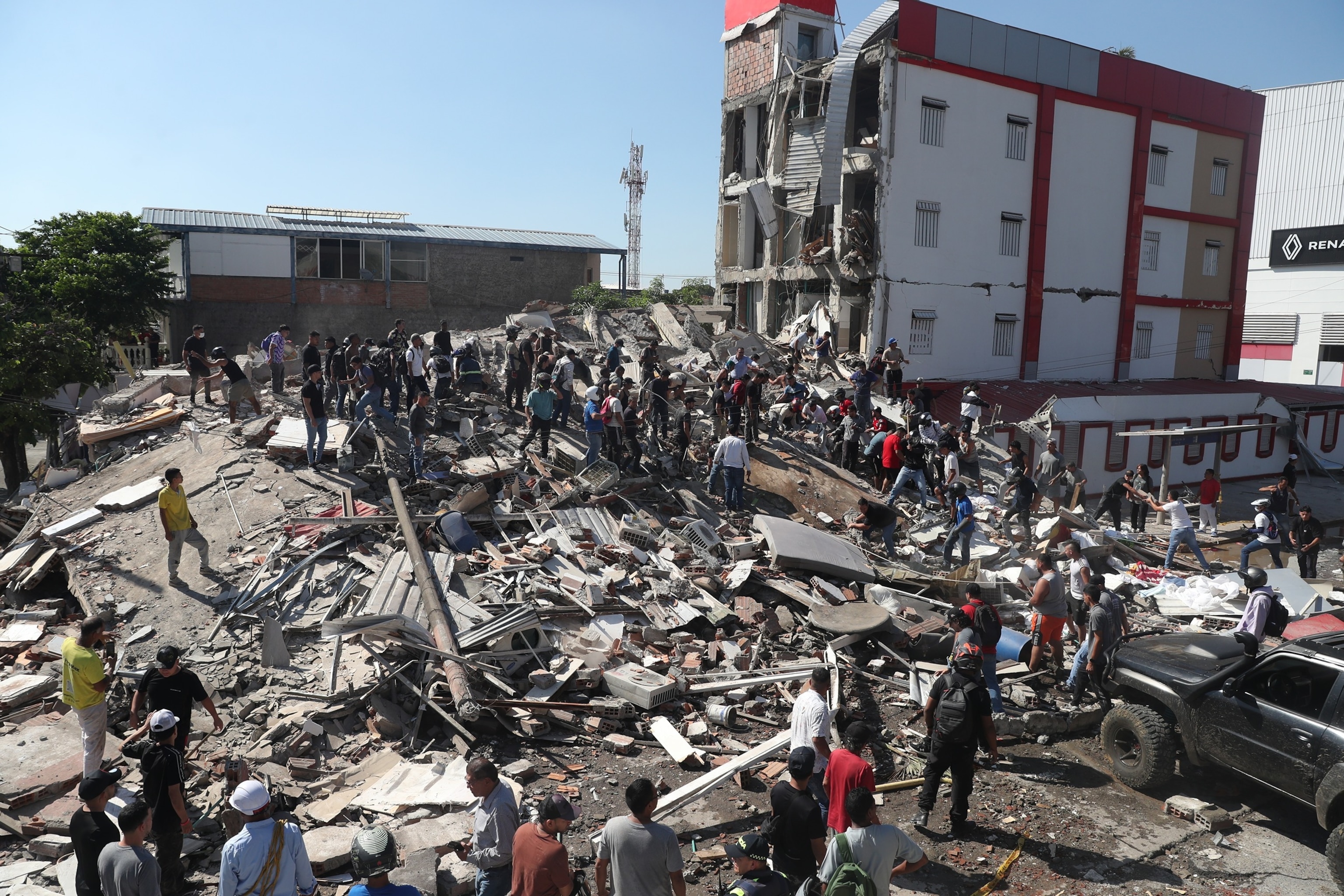 Residents and rescue workers search through the rubble of a collapsed building after an earthquake struck Cali, Colombia, Aug. 10, 2026.Santiago Saldarriaga/AP