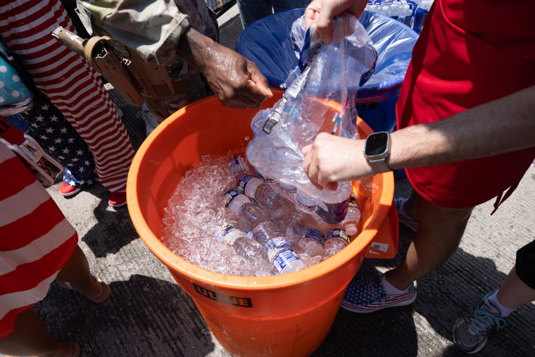 Water bottles are added to a bucket of ice at the Great American State Fair on the National Mall in Washington on July 4.Anna Rose Layden / Getty Images